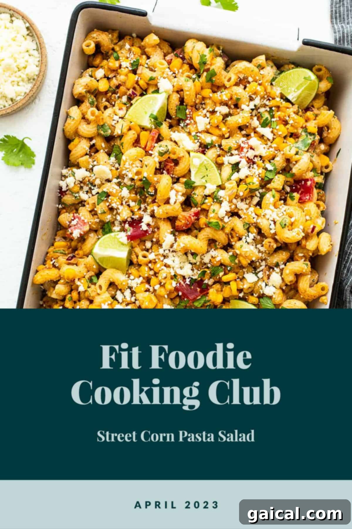 A beautifully plated bowl of vibrant Street Corn Pasta Salad, garnished with fresh cilantro and a lime wedge.