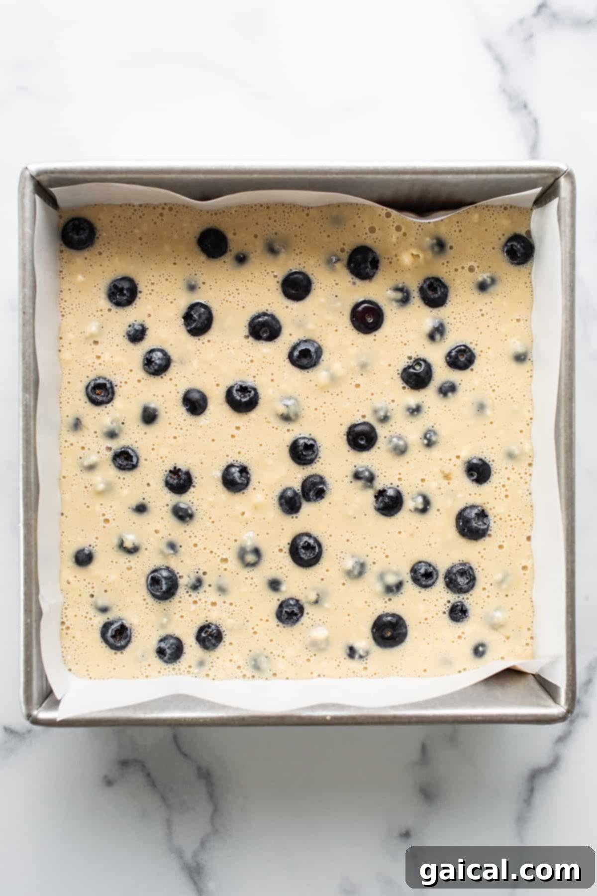 Golden Blueberry Coffee Cake 4 A freshly baked blueberry breakfast cake cooling on a wire rack, steam gently rising.