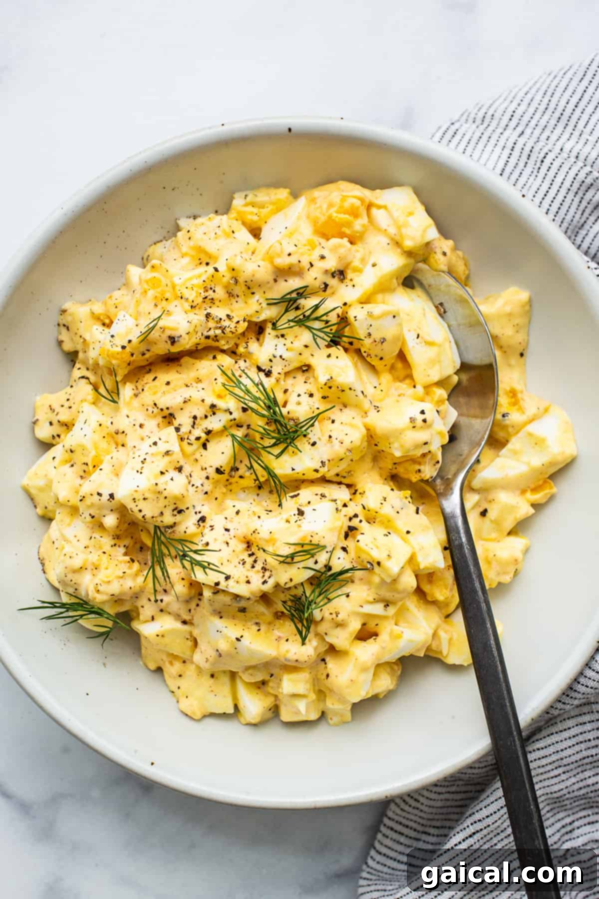Learn how to make egg salad with this super simple egg salad recipe made with hard boiled eggs and a yummy sauce. A vibrant, generously portioned bowl of classic egg salad, perfectly creamy and ready to be enjoyed.