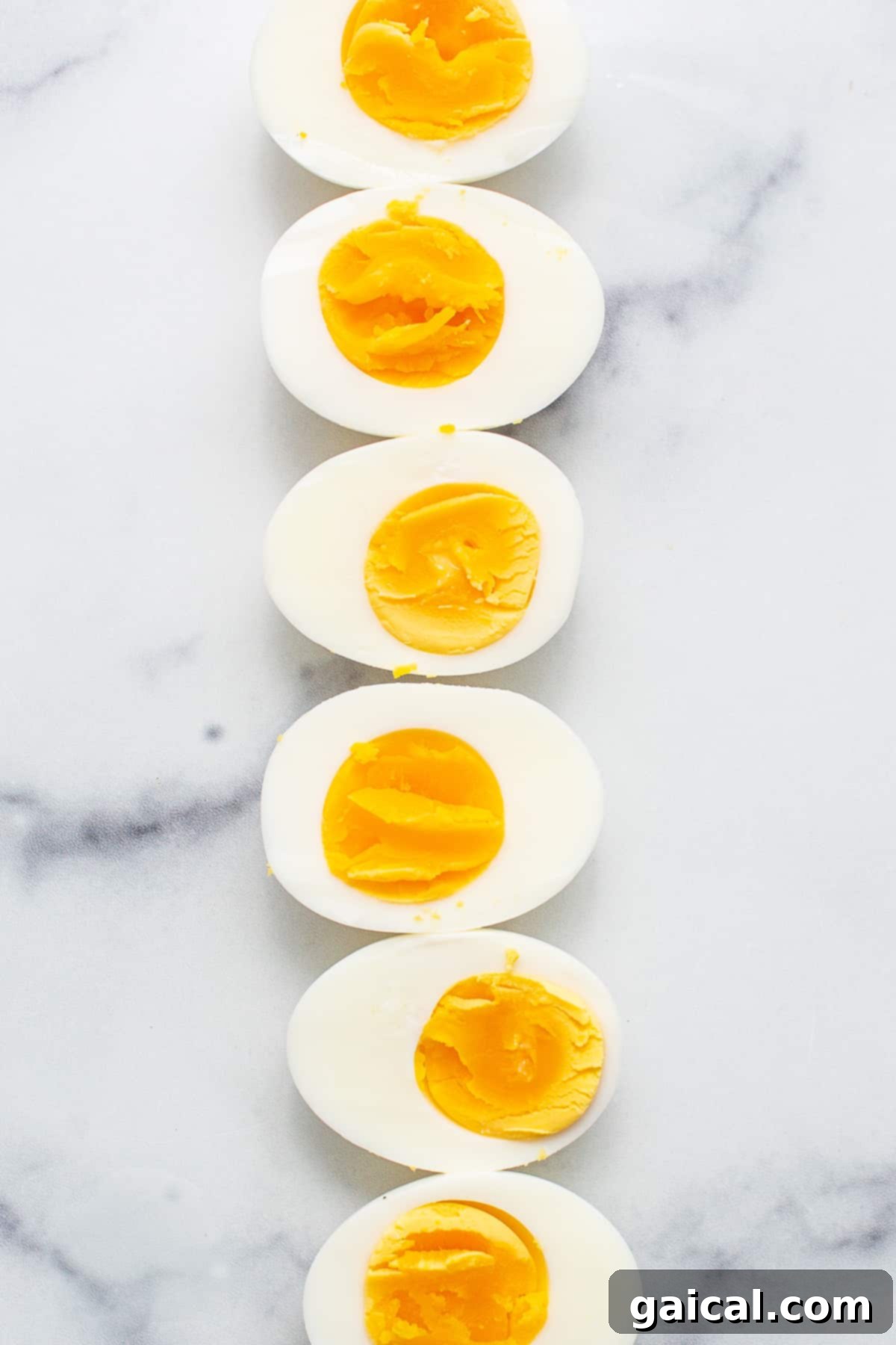 Learn how to make egg salad with this super simple egg salad recipe made with hard boiled eggs and a yummy sauce. Freshly hard-boiled eggs cooling in a large bowl on a kitchen counter, awaiting peeling.