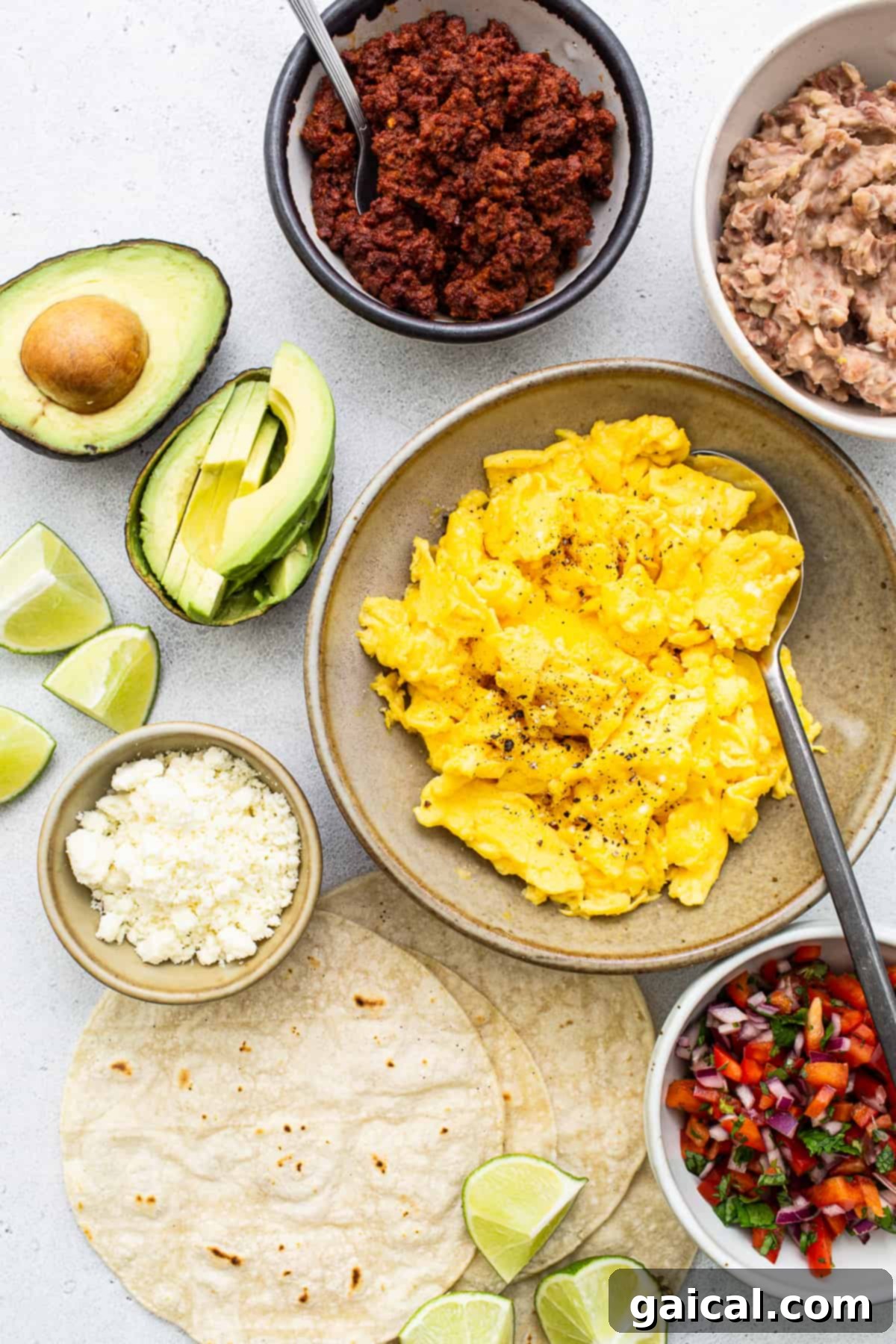 Fresh Ingredients for Homemade Breakfast Tacos Assortment of fresh ingredients for breakfast tacos, including eggs, tortillas, chorizo, beans, and various vegetables for toppings.