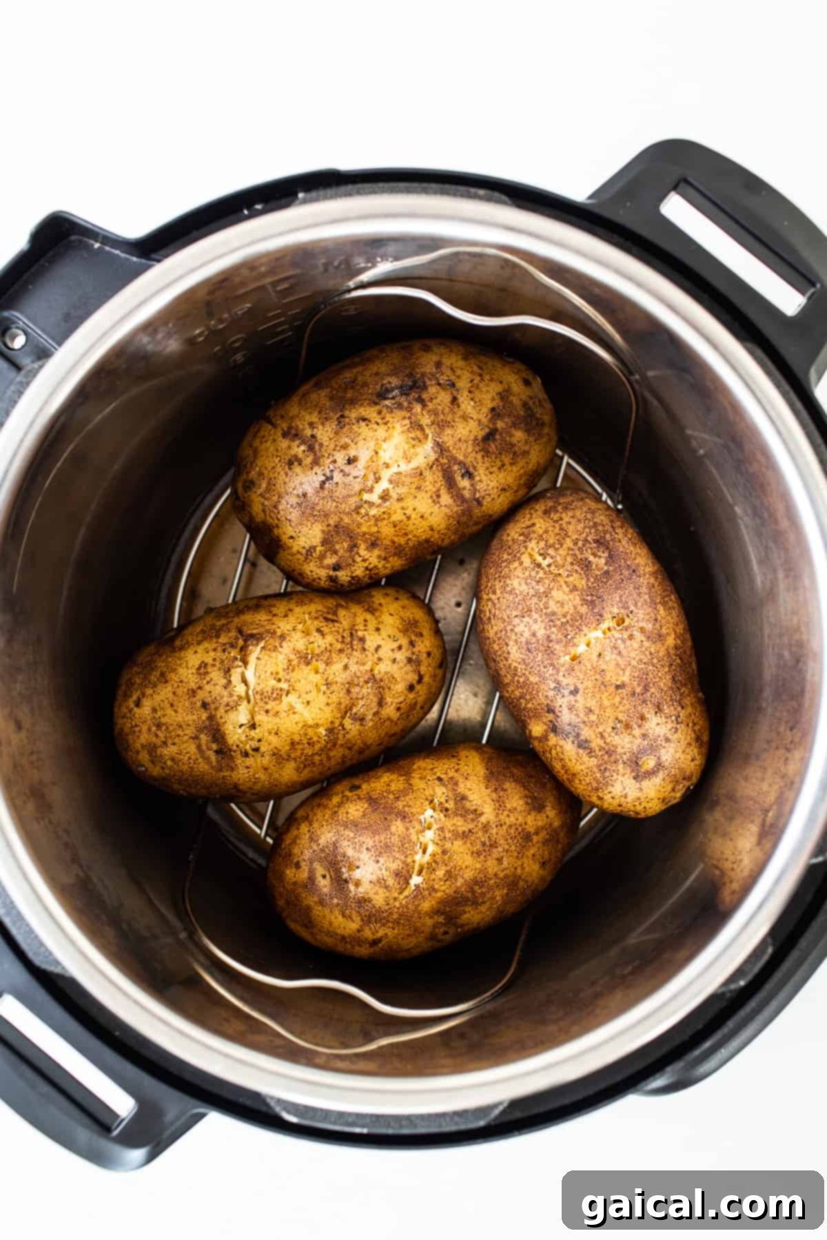 Baked potatoes cooking inside an Instant Pot.