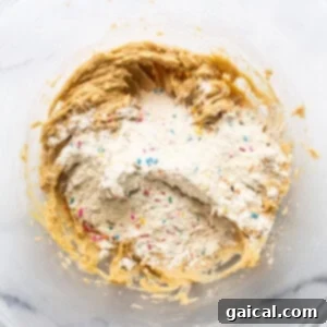 Cookie dough batter in a mixing bowl, showing its readiness for shaping.