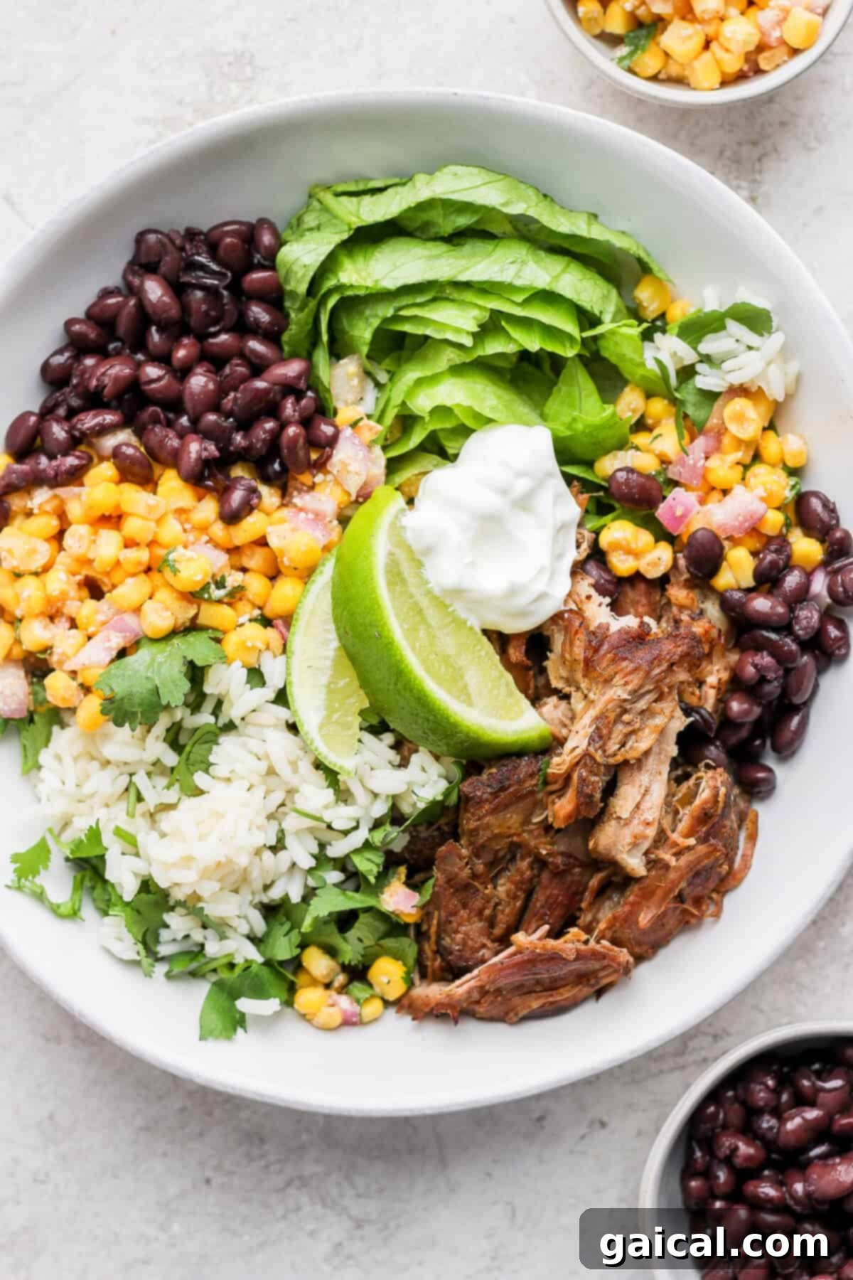 Set It And Forget It Carnitas Burrito Bowls 2 Delicious and healthy Slow Cooker Carnitas Burrito Bowl in a glass container, perfect for meal prep.