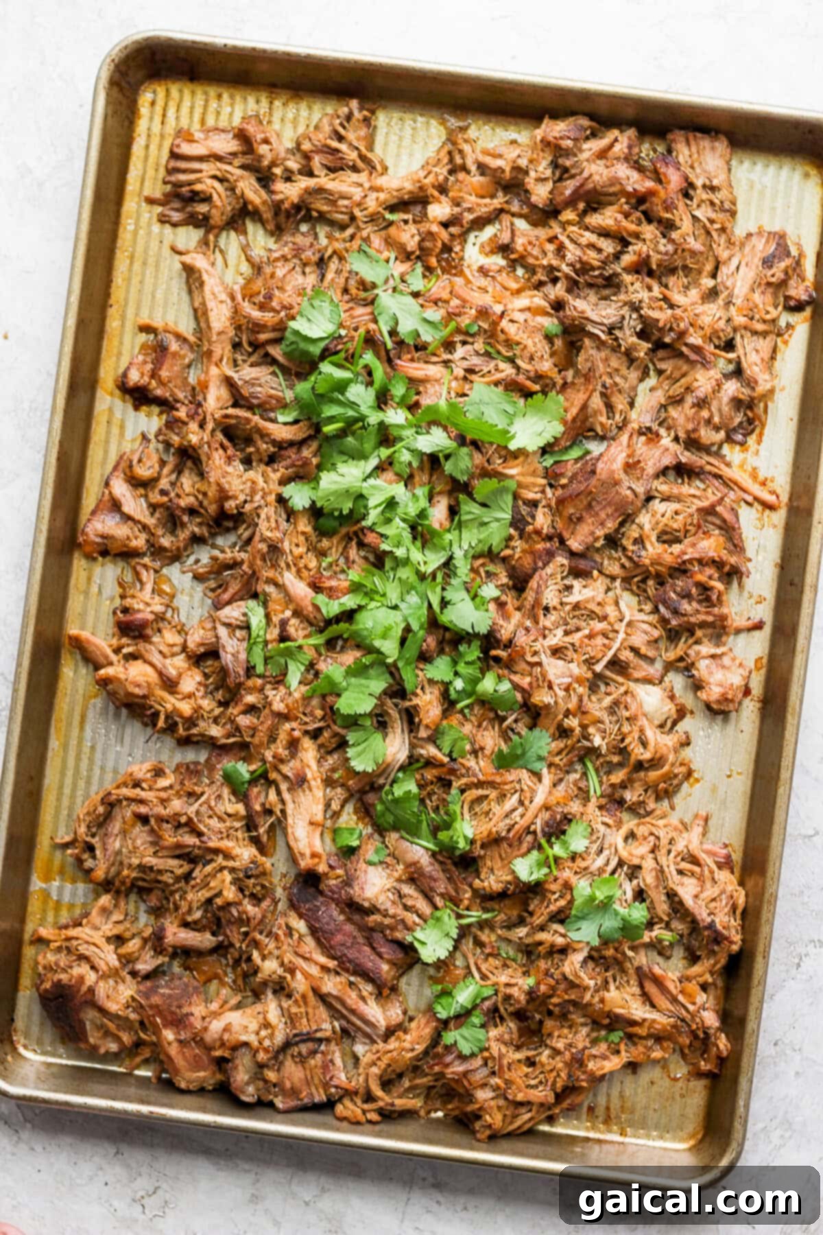 Set It And Forget It Carnitas Burrito Bowls 3 Perfectly crispy carnitas cooling on a baking sheet after broiling.