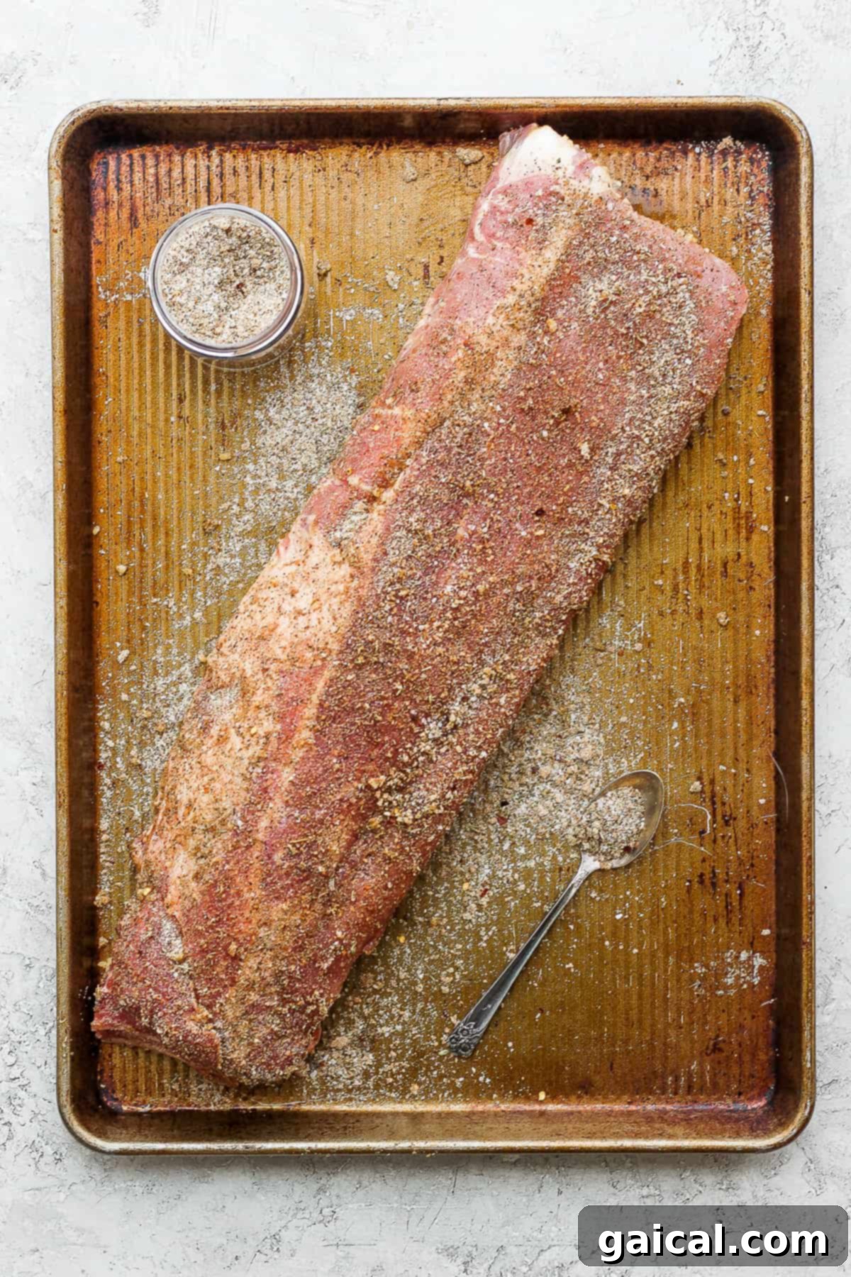 Ribs Ready for the Grill or Oven A rack of raw baby back ribs generously coated with the dry rib rub, ready for cooking.
