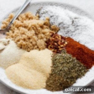 A white plate topped with various spices for the rib rub.