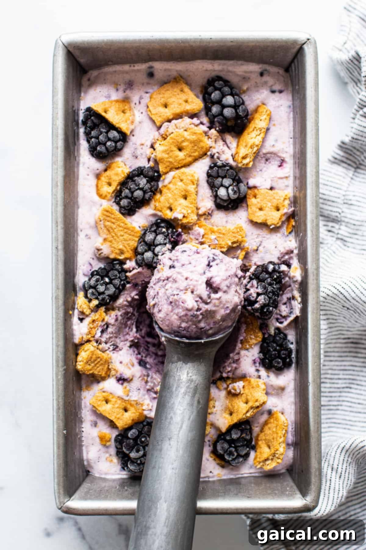 Velvet Blackberry Cheesecake Protein Chill 2 Creamy blackberry cheesecake cottage cheese ice cream in a bread pan, ready to be scooped.