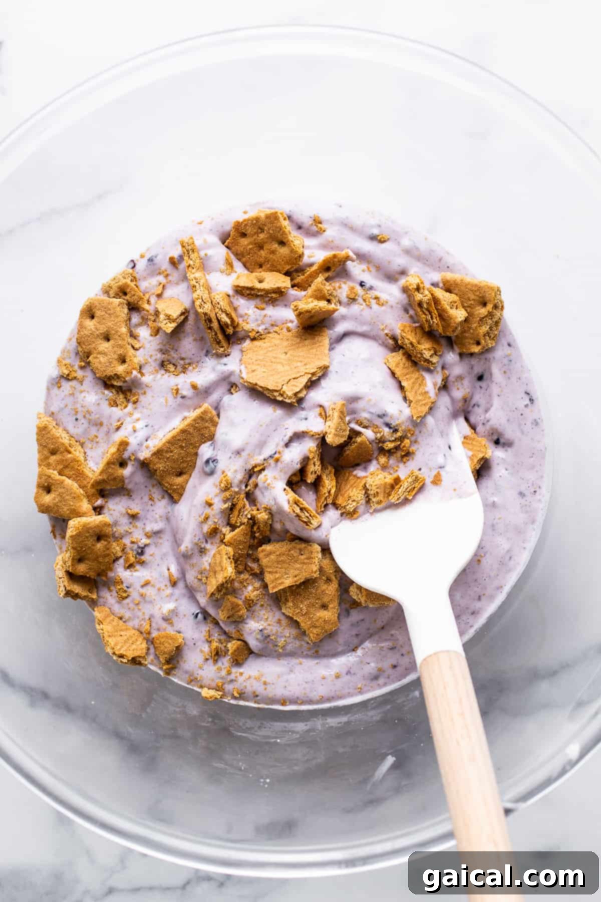 Velvet Blackberry Cheesecake Protein Chill 4 Blended cottage cheese ice cream mixture with blackberries and graham crackers in a mixing bowl before freezing.