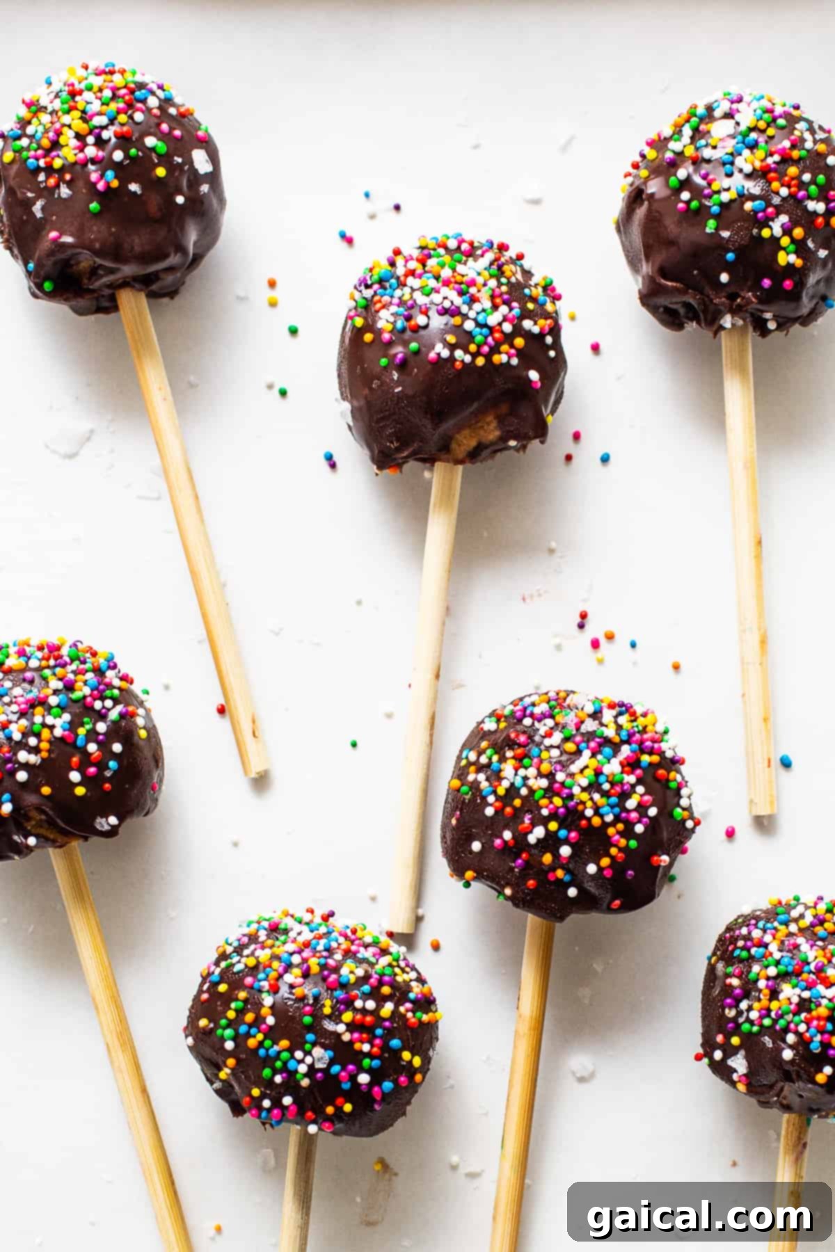 Protein-Packed Cake Pops 2 Protein cake pops covered in colorful sprinkles, arranged enticingly.