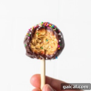 Protein cake pop with a bite taken out of it.