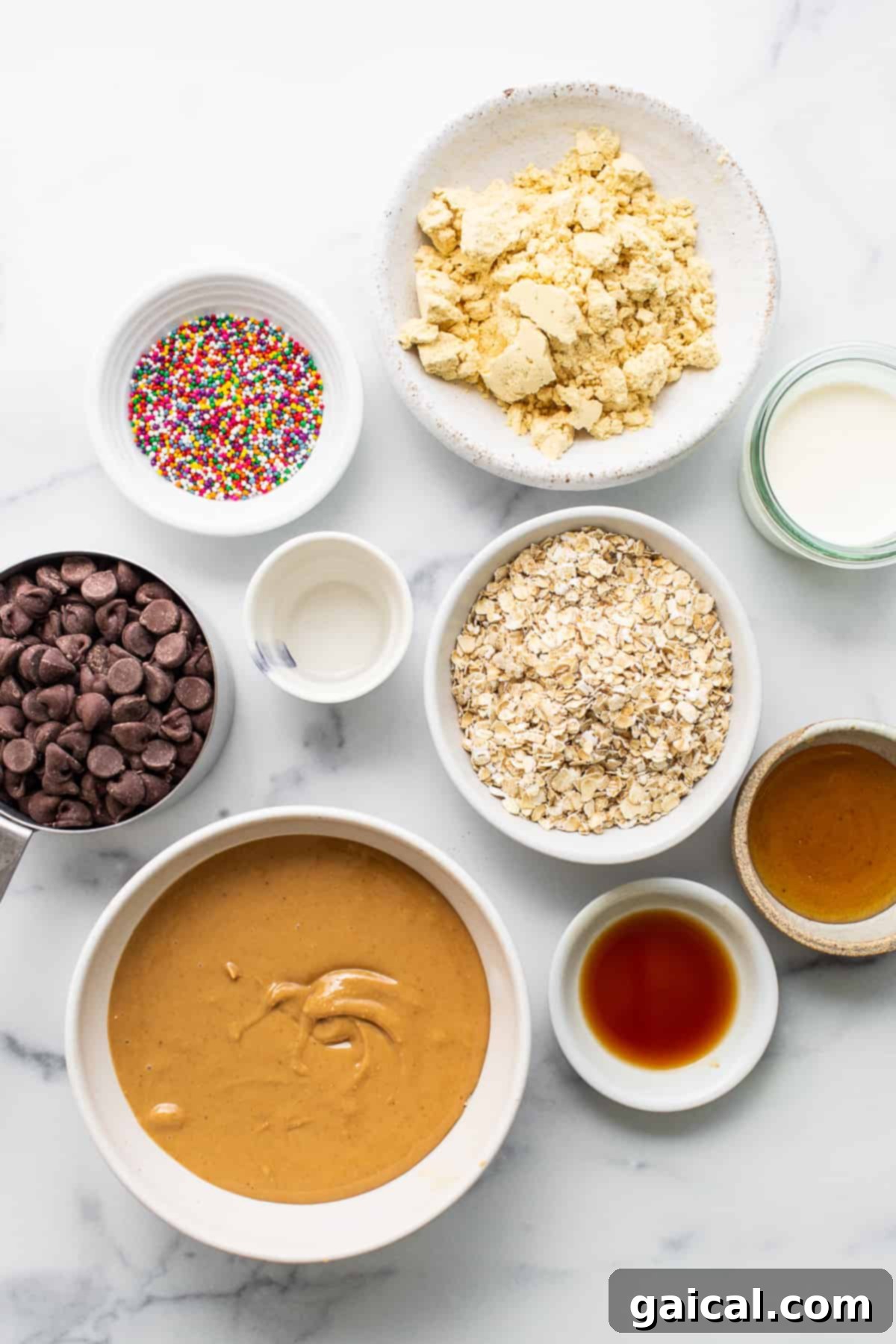 Protein-Packed Cake Pops 3 A collection of ingredients for protein cake pops, neatly arranged in separate bowls.