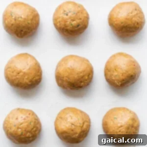 Protein cake pop balls on a cookie sheet.