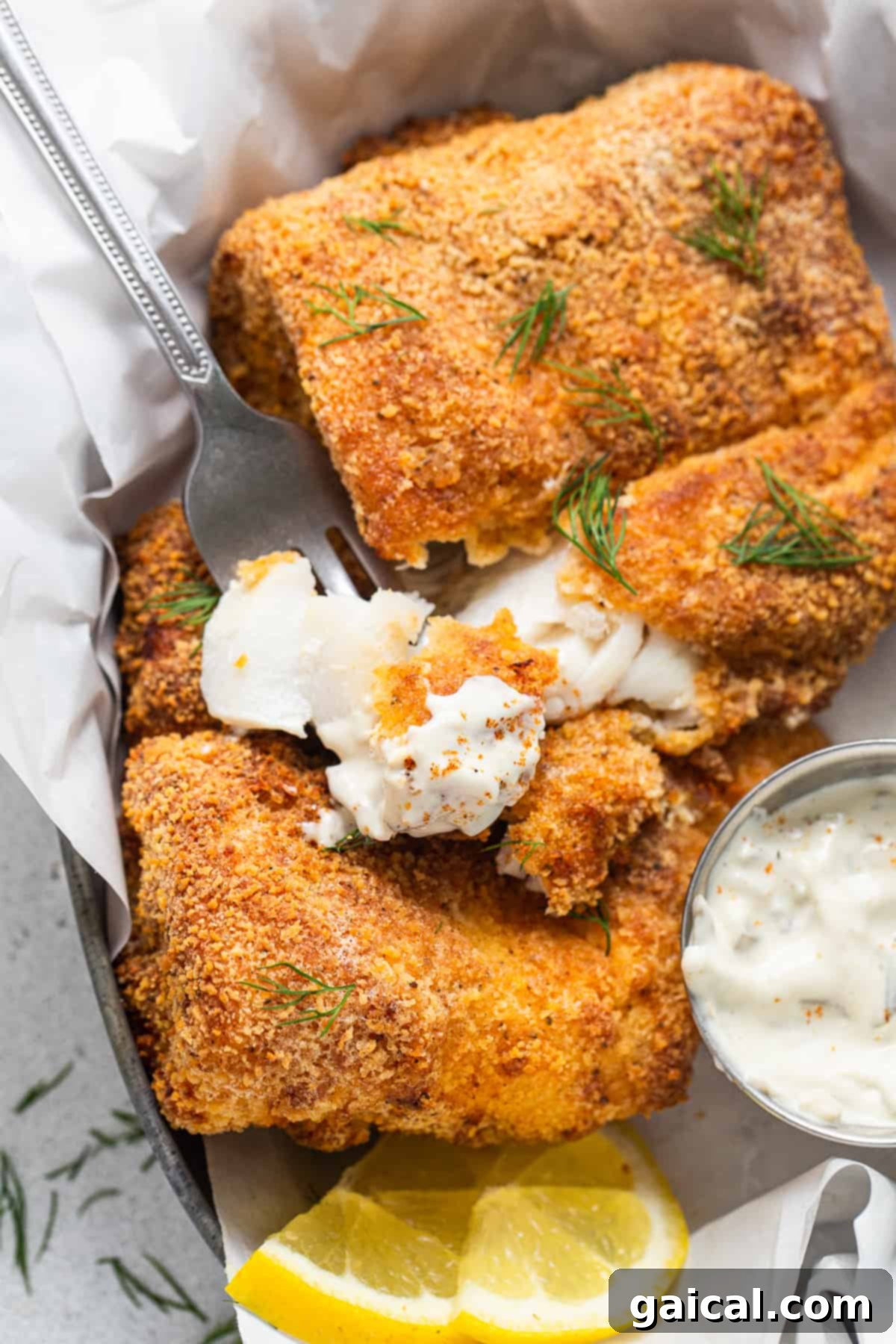 Crispy Air Fryer Fish: Your New Favorite Easy Weeknight Dinner Crispy air fryer fish served in a basket with a side of creamy tartar sauce and lemon wedges.