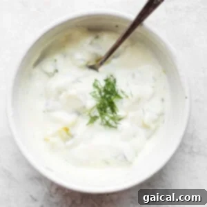 Golden Crunchy Air Fryer Fish Fillets 2 Creamy dill pickle dip in a white bowl with fresh dill garnish.