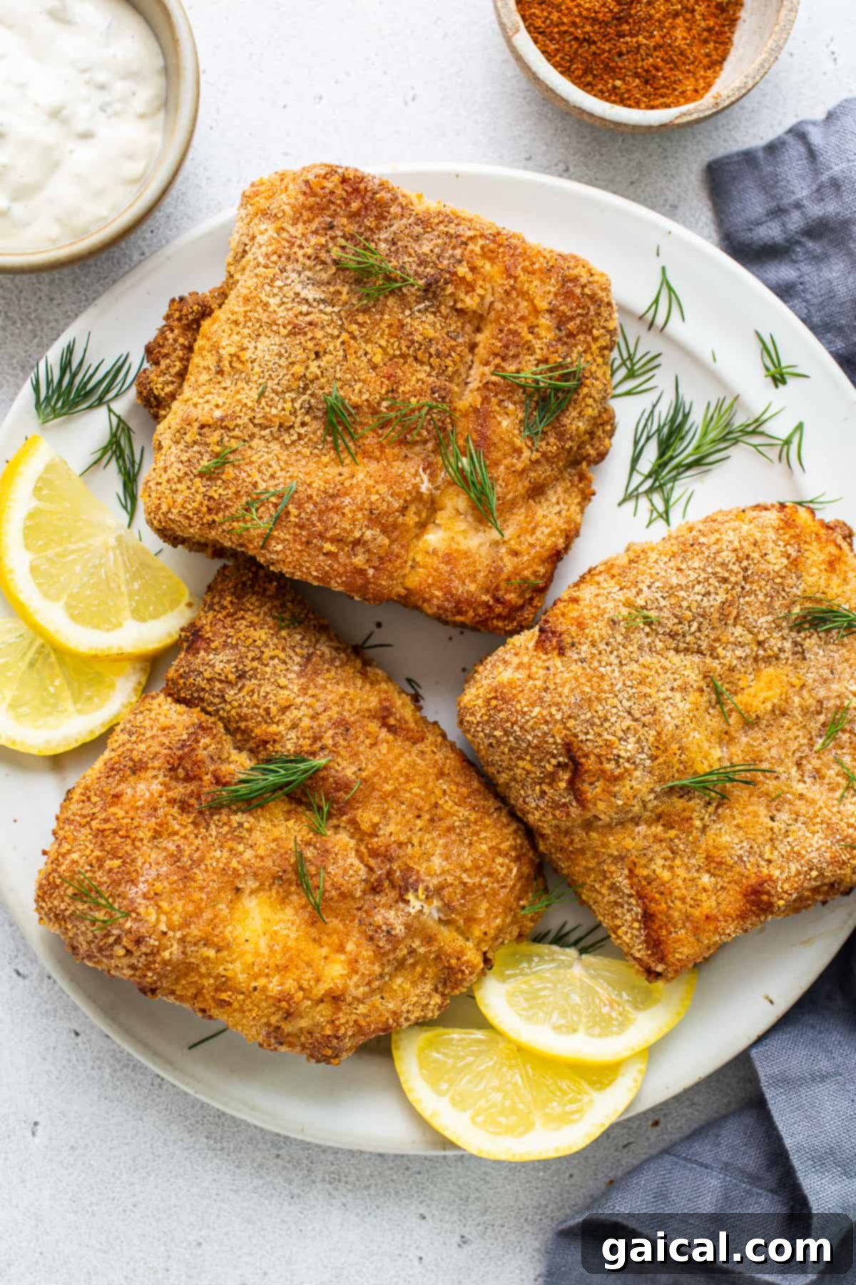 Air Fryer Fish Ready to Serve Beautifully cooked air fryer fish served on a plate with fresh lemon slices.