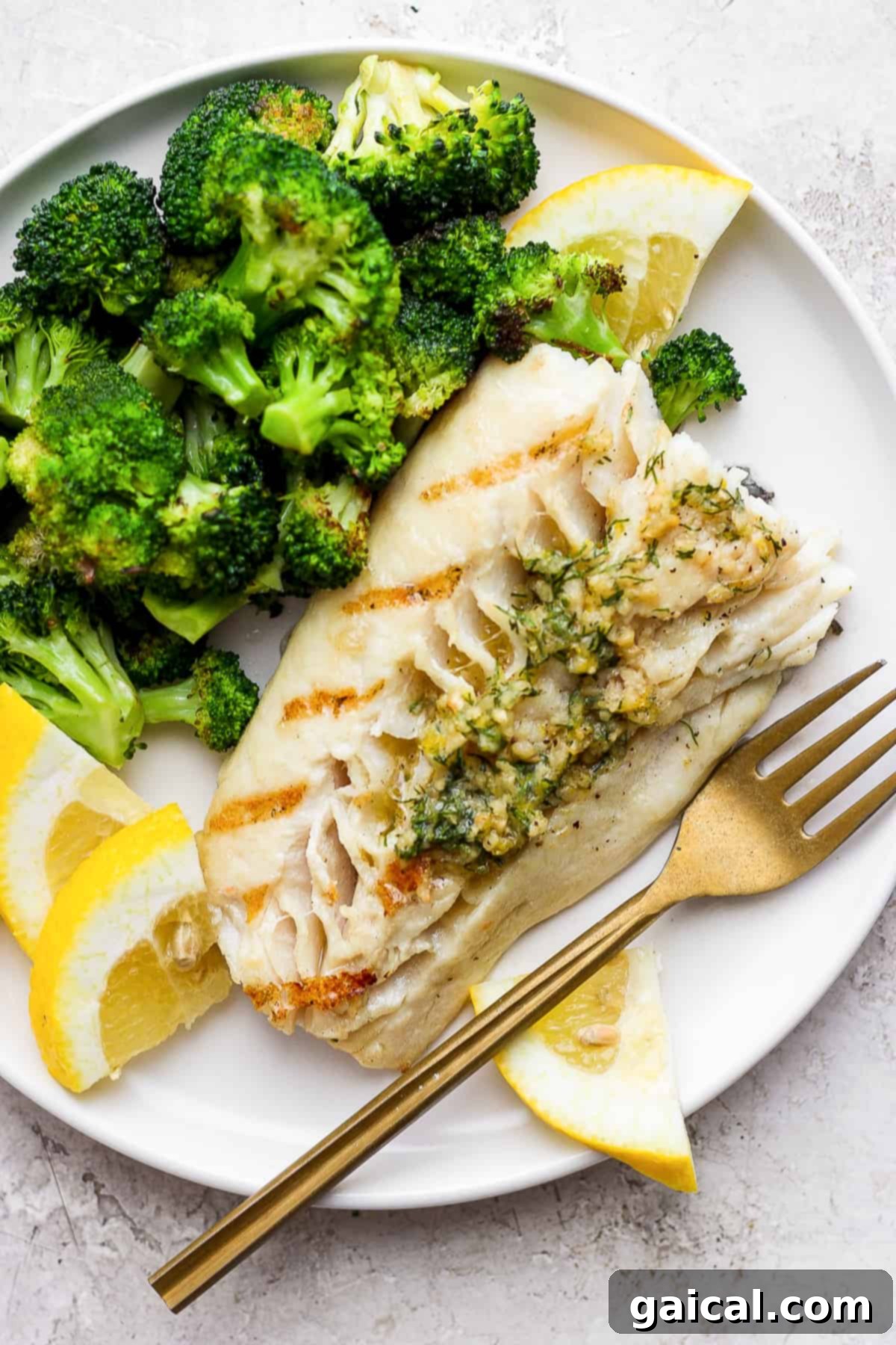 The Ultimate Grilled Fish: Smoky, Flaky, and Fresh Perfectly grilled fish fillets on a plate, garnished with fresh herbs and served alongside vibrant green broccoli.