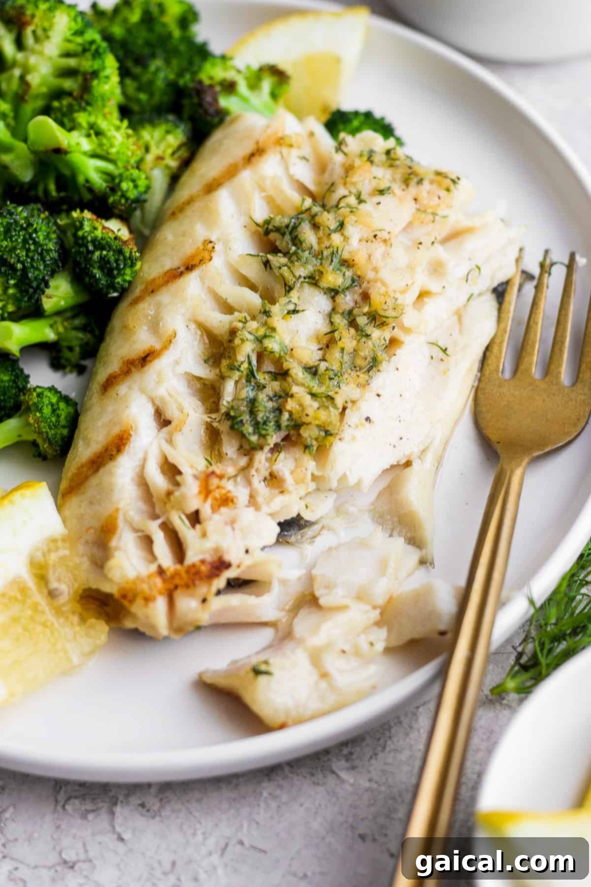 A Delicious and Healthy Meal Awaits! A final close-up of the grilled fish on a plate, garnished with fresh herbs and a side of broccoli, emphasizing its appealing texture and presentation.