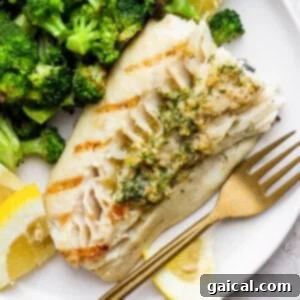 Delicious grilled fish on a plate with broccoli.