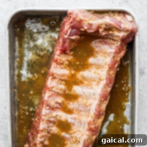 a piece of meat sitting on top of a pan covered in sauce.
