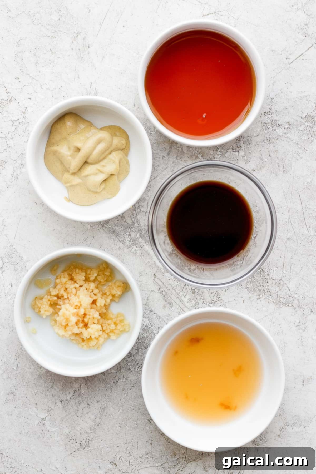 This classic rib marinade recipe is perfectly savory and sweet with only 5 ingredients -- an amazing complement to your baby back ribs. Enjoy! Rib marinade ingredients in bowls.