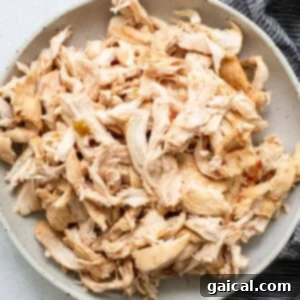 Set-It-and-Forget-It Chicken Tortilla Soup 7 Shredded chicken in a bowl next to a napkin.