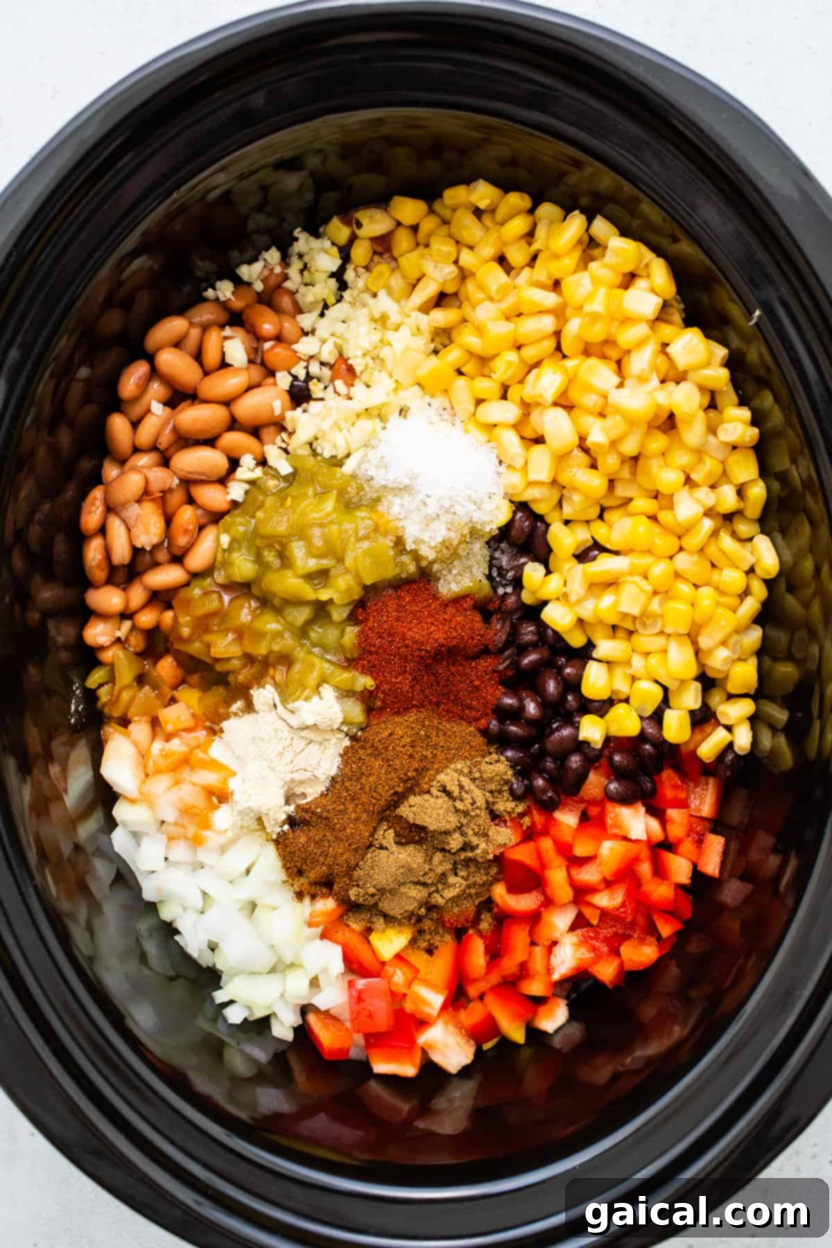 Essential Ingredients for Chicken Tortilla Soup Assorted fresh ingredients for chicken tortilla soup arranged in a slow cooker, ready for cooking.