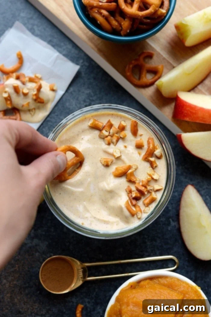 Pumpkin Spice Greek Yogurt Dip 4 Three small bowls of pumpkin yogurt dip, showcasing variations with different toppings and textures, such as chocolate chips or a swirl.