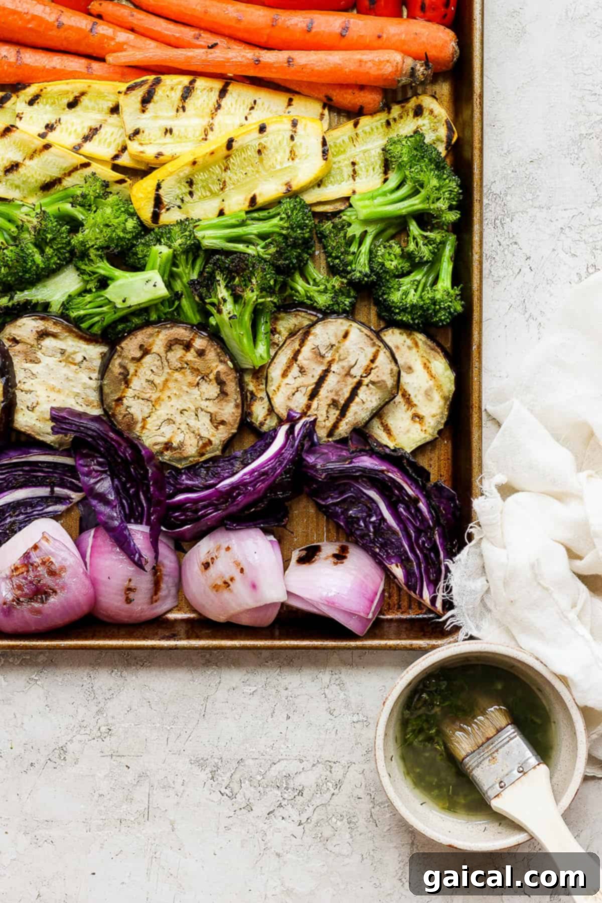 A bountiful tray of vibrant grilled vegetables accompanied by a steaming bowl of soup, creating a comforting and wholesome meal scene.