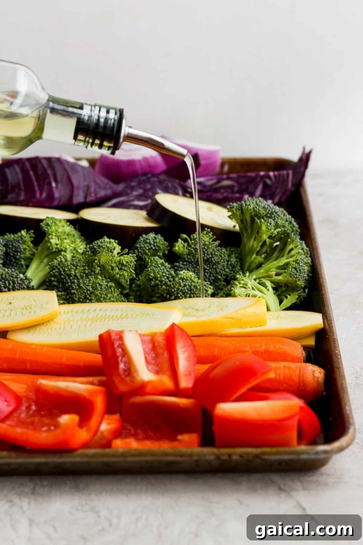 A beautifully arranged tray of fresh, colorful vegetables awaiting the grill, with a bottle of wine in the background, hinting at a delightful meal.