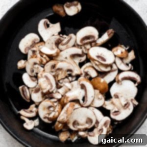 mushrooms in a skillet on a white background.