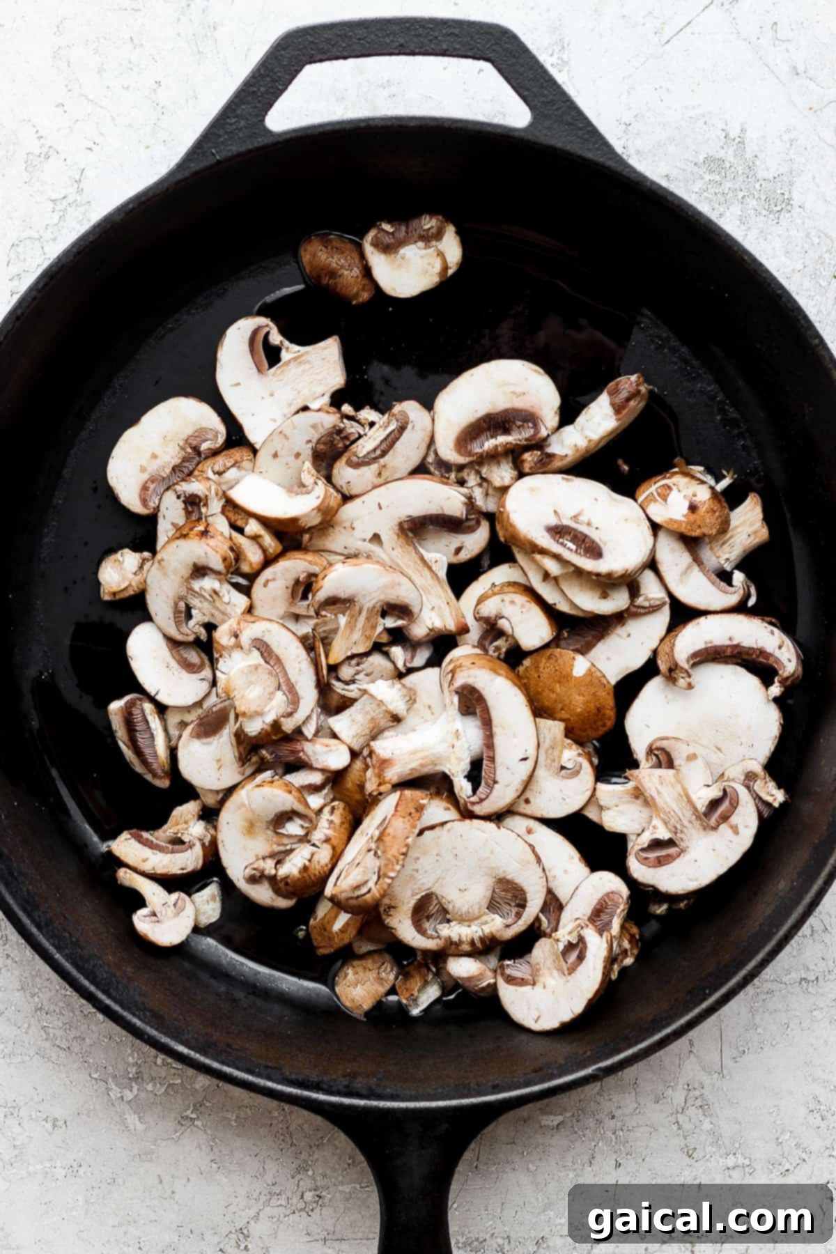 mushrooms in a skillet on a white background.