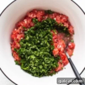 Sunshine Corn Salsa 10 Chopped tomatoes and herbs mixing in a bowl.