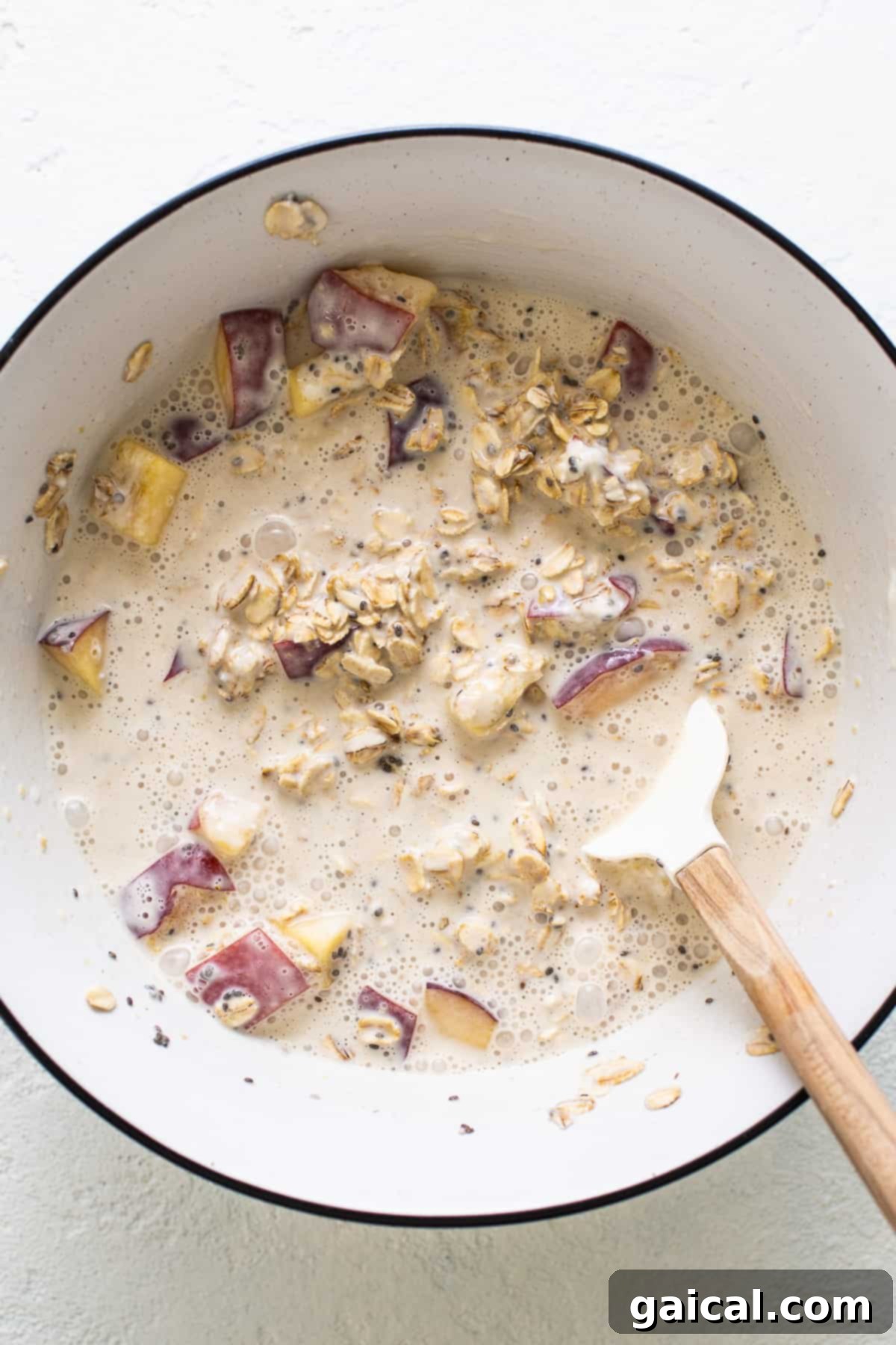 Golden Peach Overnight Bliss 4 A large mixing bowl containing all the ingredients for peach overnight oats, ready to be combined.