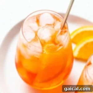 Iconic Aperol Spritz 5 Aperol spritz in a glass with a straw.