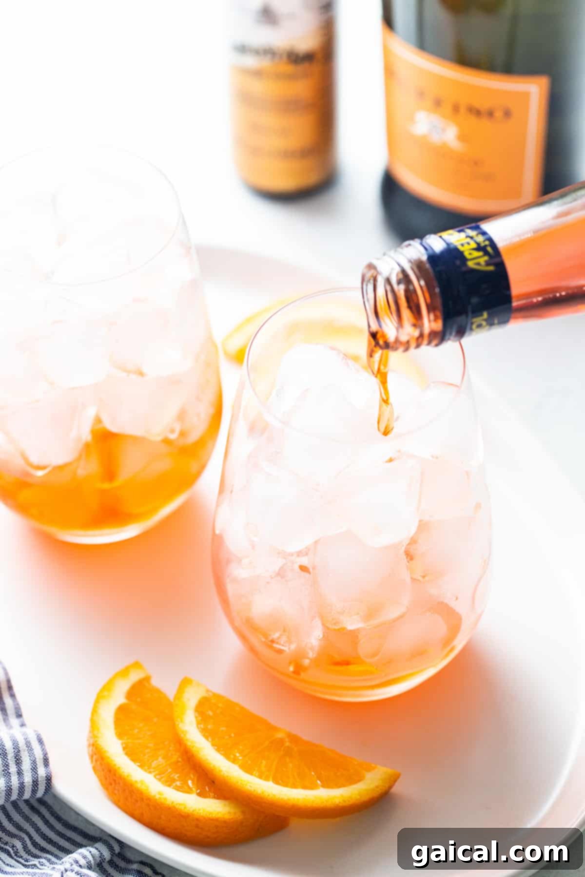 Crafting the perfect Aperol Spritz, one pour at a time. The process of pouring Aperol into a glass for an Aperol Spritz, demonstrating proper technique.