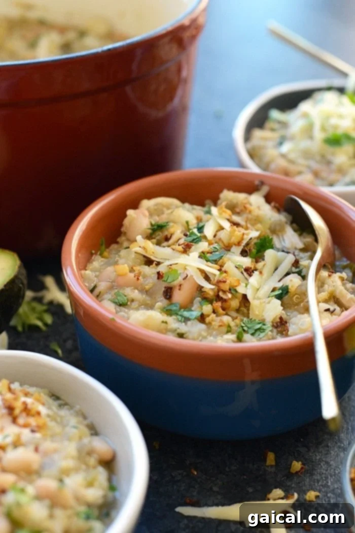 Wholesome White Chicken Quinoa Chili 4 A vibrant overhead shot of the White Chicken Quinoa Chili in a rustic bowl, showcasing its rich texture and colorful toppings.
