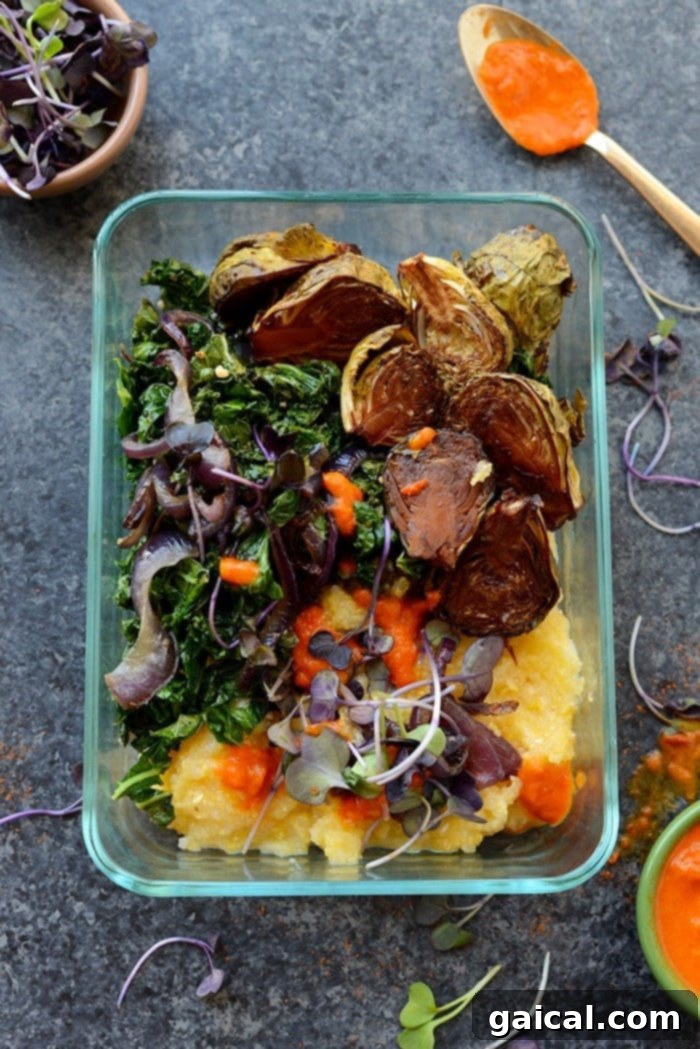 Caramelized Brussels & Creamy Polenta Bowls 4 Overhead shot of a healthy vegetarian meal prep bowl with polenta, roasted Brussels sprouts, and a vibrant sauce.