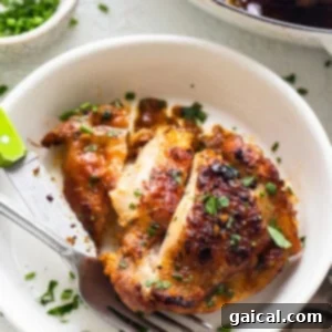 Chicken breast in a white plate with a fork.