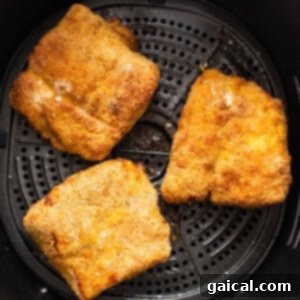 Air fryer fish in an air fryer basket.