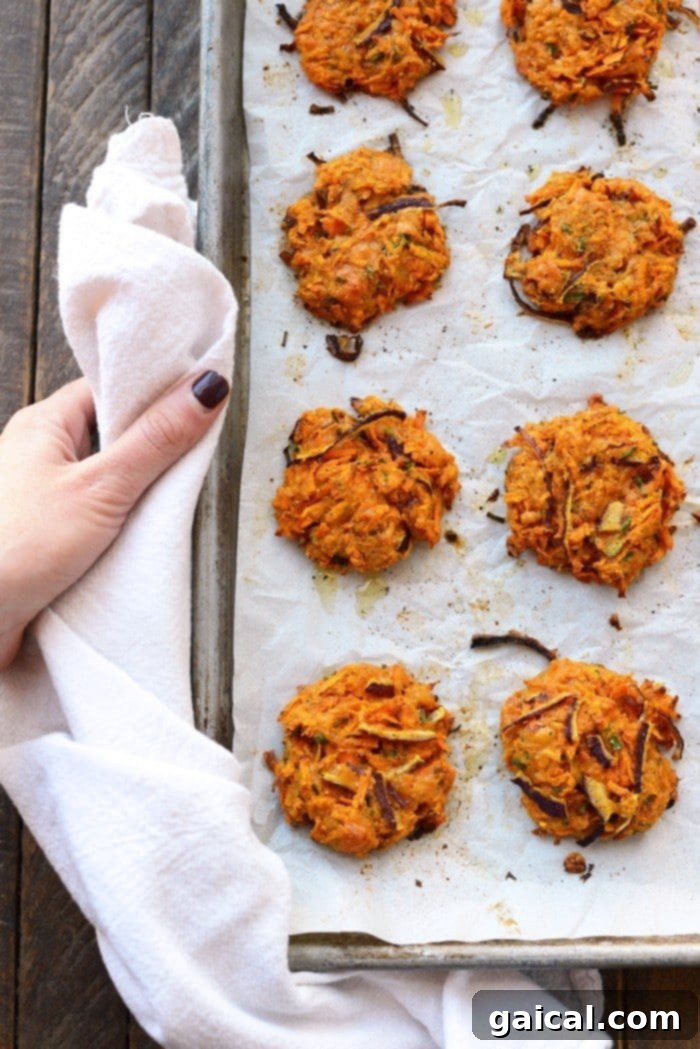 Baked Sweet Potato Hash Browns Cooling Baked cheddar sweet potato hash browns fritters cooling on a baking tray after being removed from the oven.