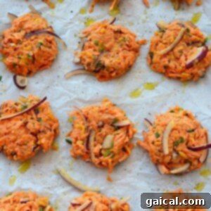 Sweet Potato Cheddar Crisps 4 A tray of uncooked cheddar sweet potato hash browns patties arranged on a baking sheet, ready for the oven.