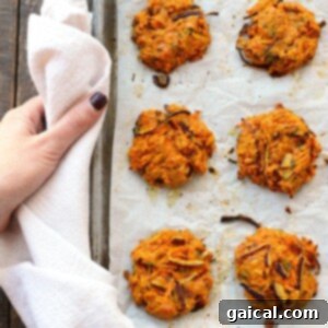 Sweet Potato Cheddar Crisps 5 Freshly baked cheddar sweet potato patties with golden-brown edges on a baking sheet, straight from the oven.