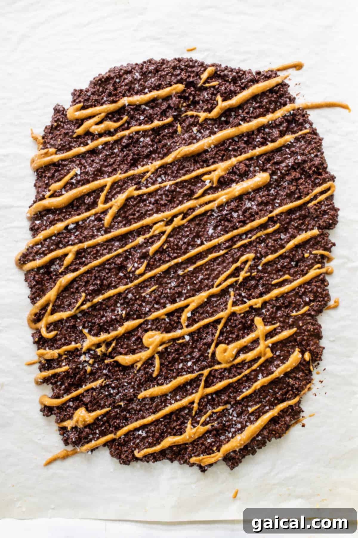 A piece of rich chocolate bark with a luscious caramel drizzle on top, showcasing potential delicious variations and inspiring other decadent chocolate creations.