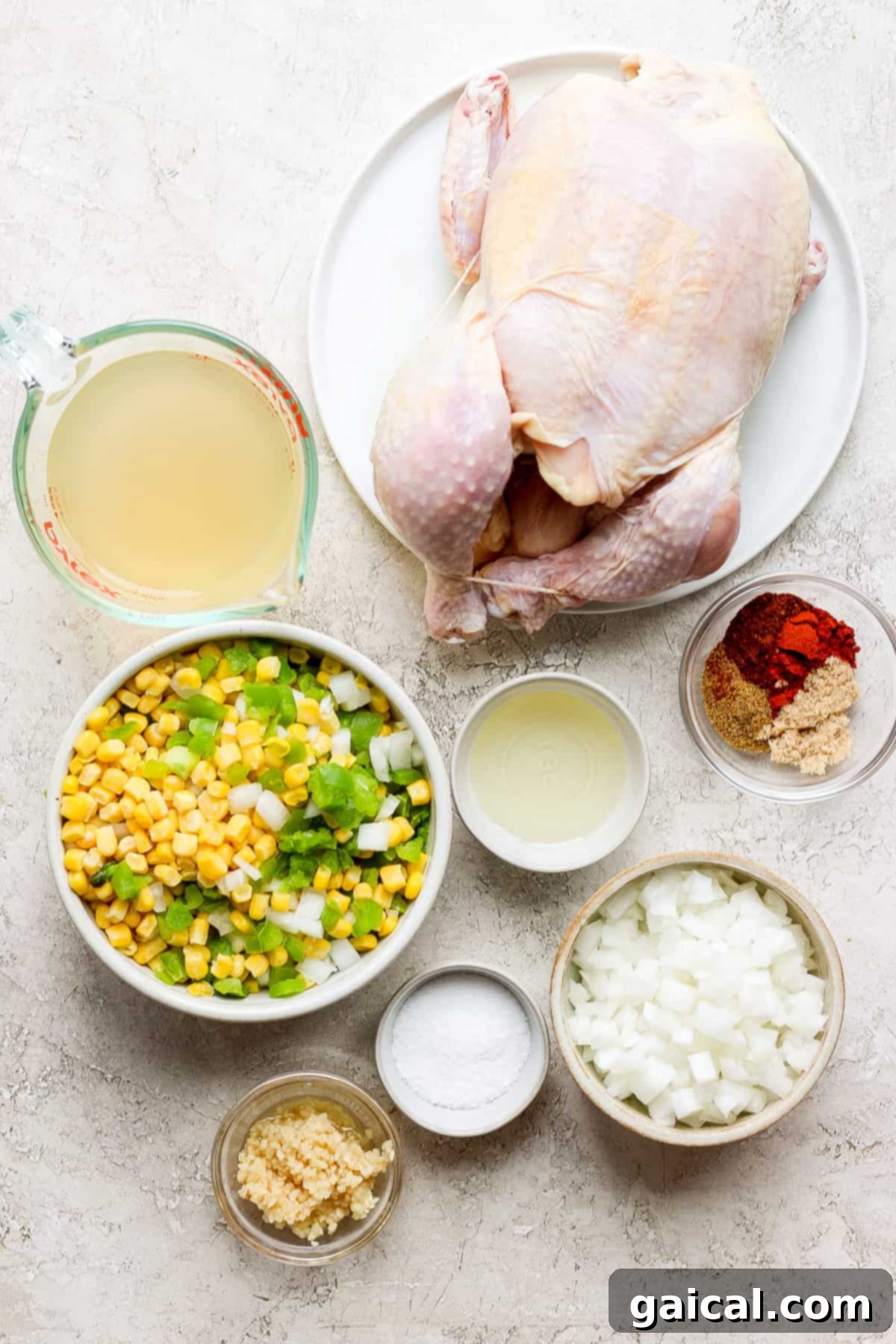 One-Pot Spanish Roast Chicken Dinner 3 Various ingredients for the Spanish chicken and rice laid out on a wooden table.