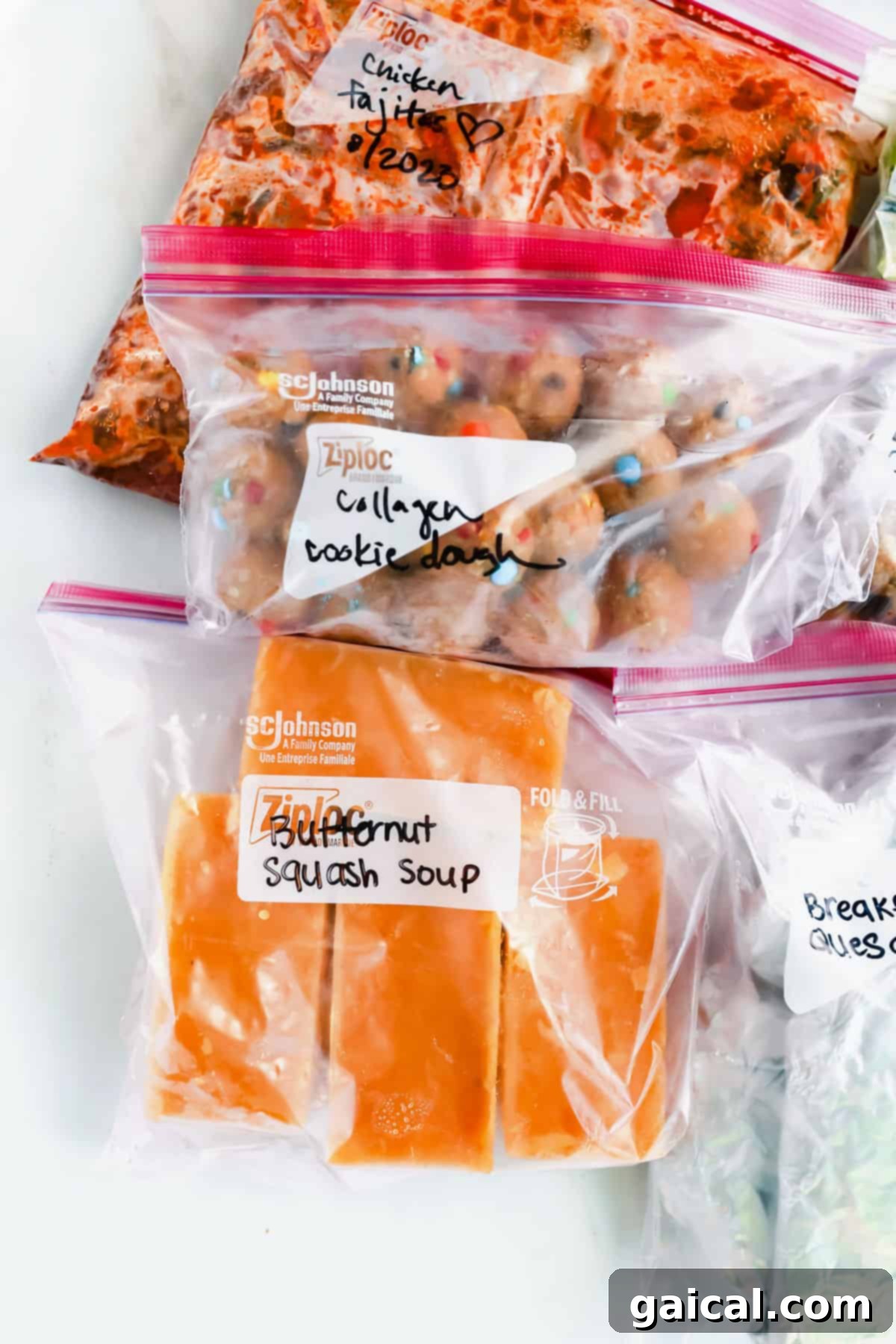 Various prepped freezer meals in labeled plastic bags, ready for storage.