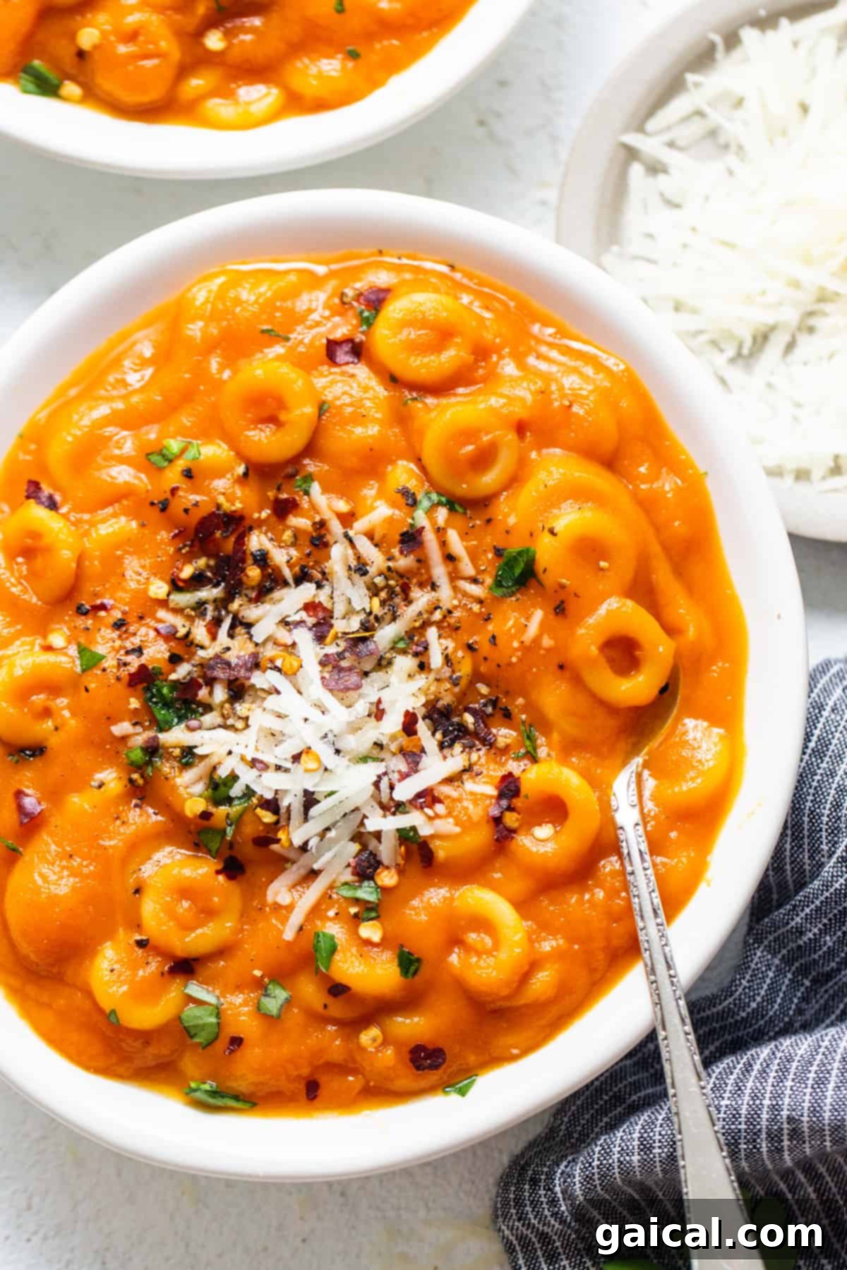 Stealthy One-Pan Spaghettios 2 two bowls filled with pasta and cheese on top of a table.