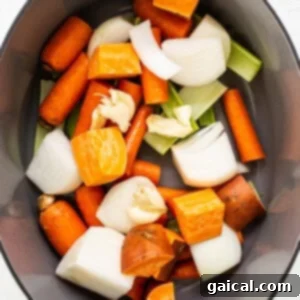 a pan filled with carrots, onions and celery.