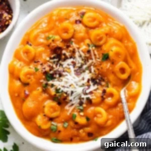 a white bowl filled with pasta and cheese.