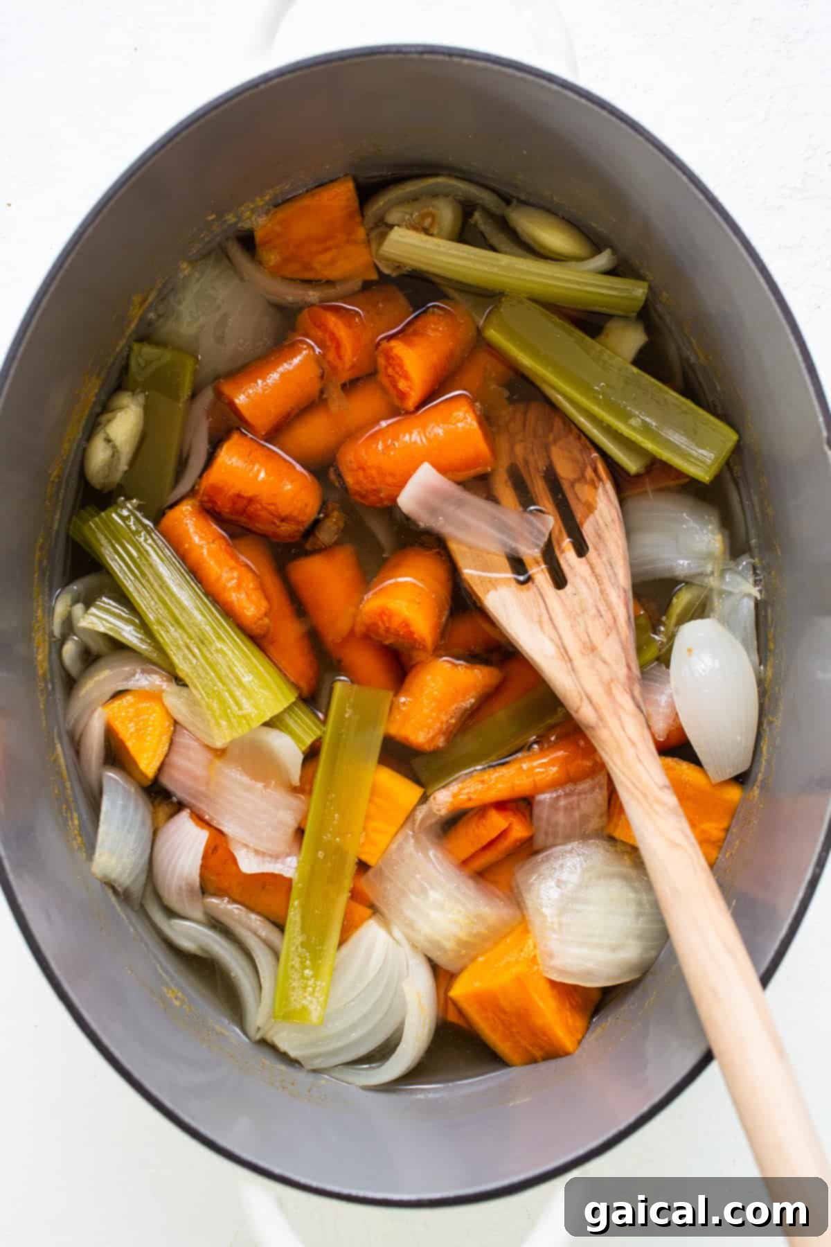 Stealthy One-Pan Spaghettios 3 a pot filled with carrots, celery and onions.